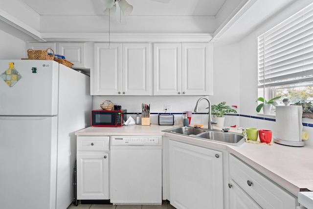 kitchen with white appliances, white cabinets, sink, ceiling fan, and ornamental molding