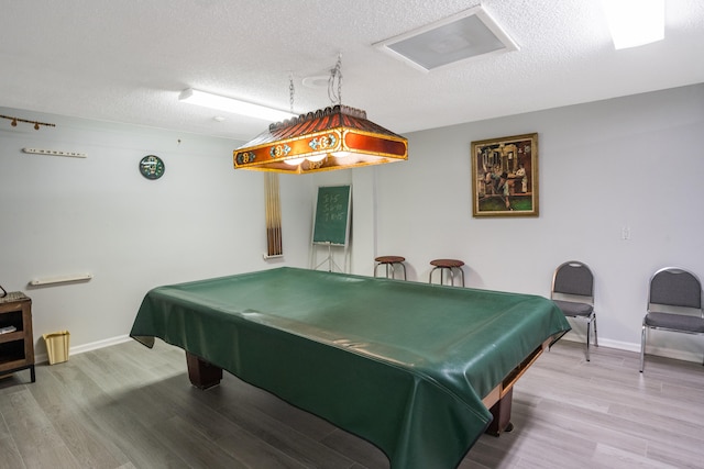 playroom featuring hardwood / wood-style floors, a textured ceiling, and pool table