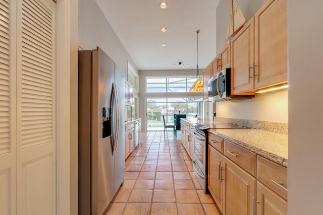 kitchen featuring light stone countertops, light brown cabinetry, stainless steel appliances, light tile patterned floors, and decorative light fixtures