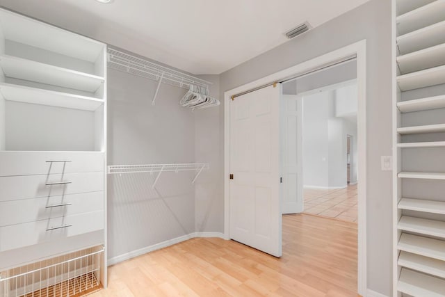 walk in closet featuring wood-type flooring