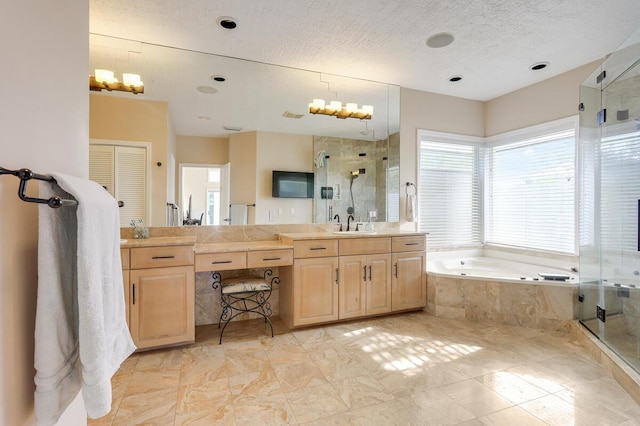 bathroom with vanity and shower with separate bathtub