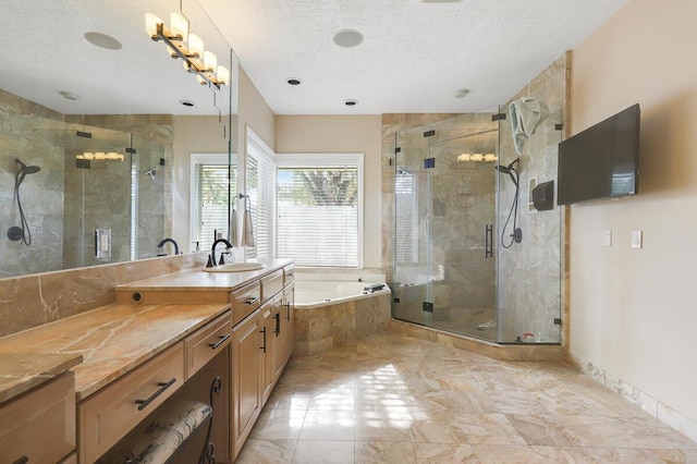 bathroom with vanity, a textured ceiling, and independent shower and bath