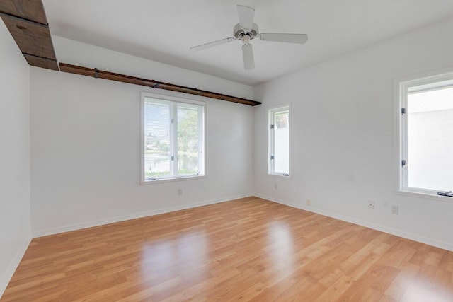 spare room featuring light wood-type flooring and ceiling fan