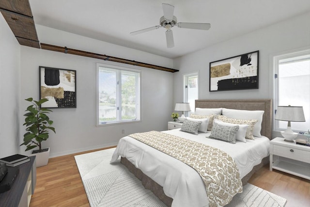 bedroom with light hardwood / wood-style flooring and ceiling fan