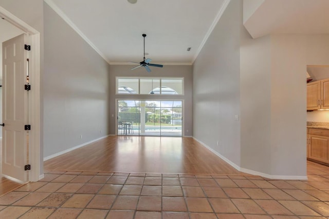 unfurnished room with ceiling fan, light tile patterned flooring, and ornamental molding