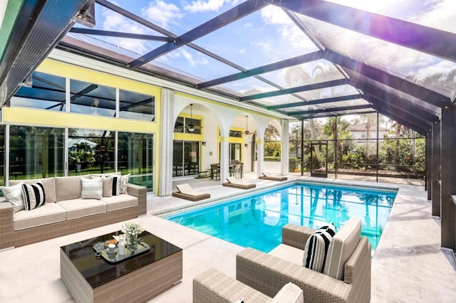 view of swimming pool with glass enclosure, a patio, and an outdoor hangout area