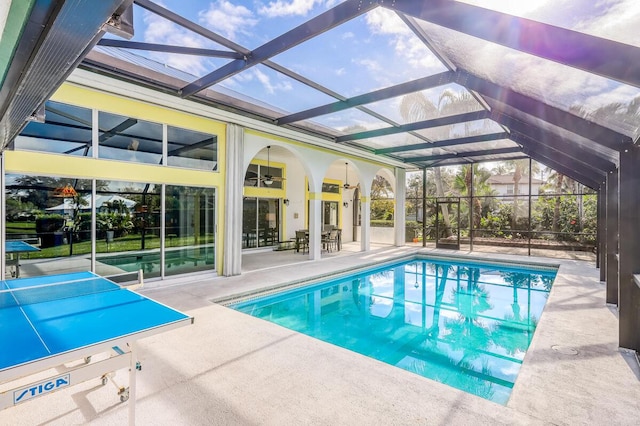 view of swimming pool with a lanai, ceiling fan, and a patio