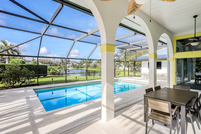 view of pool with ceiling fan, a patio, and glass enclosure