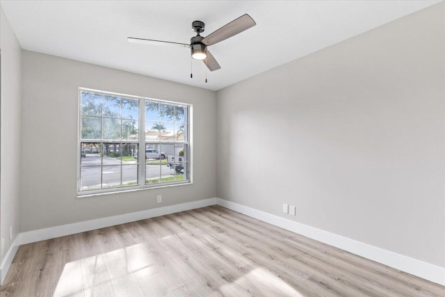 spare room with light wood-type flooring and ceiling fan