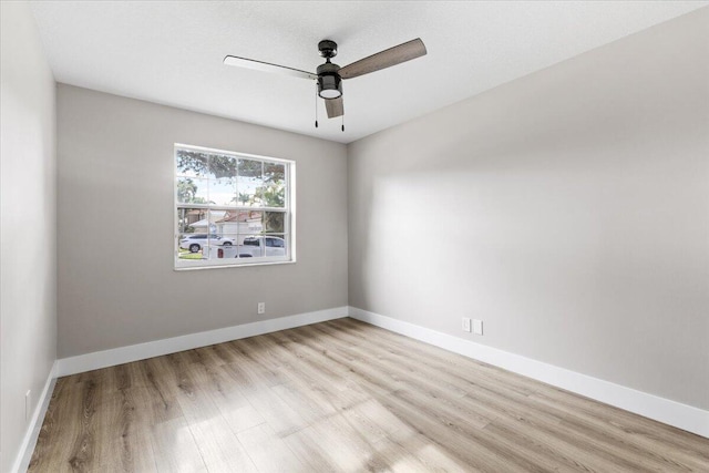 spare room featuring light hardwood / wood-style floors and ceiling fan