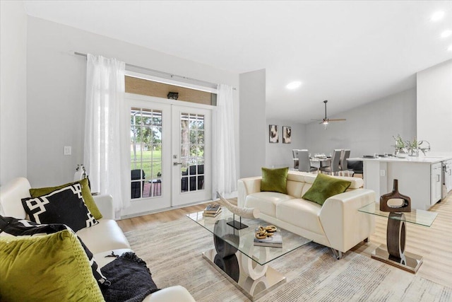 living room with ceiling fan, light wood-type flooring, and french doors