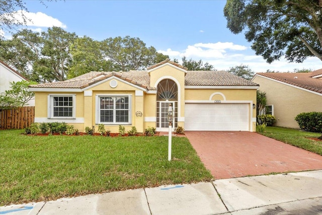 mediterranean / spanish-style house with a garage and a front yard