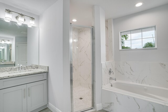 bathroom with vanity and separate shower and tub