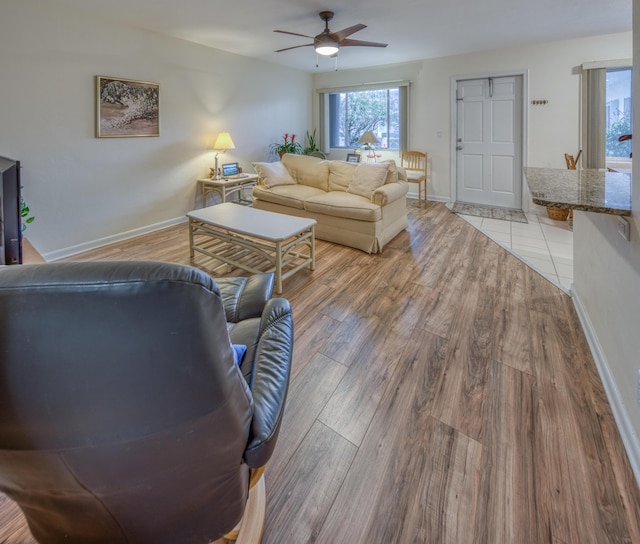 living room featuring ceiling fan and light wood-type flooring