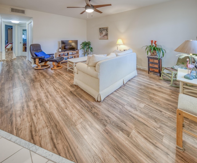 living room with ceiling fan and wood-type flooring