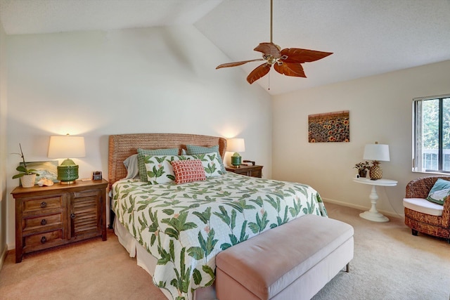 bedroom featuring vaulted ceiling, light colored carpet, and ceiling fan