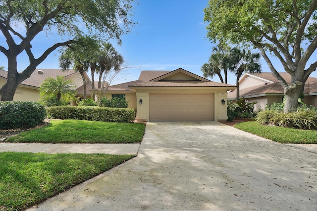 single story home with a garage and a front yard