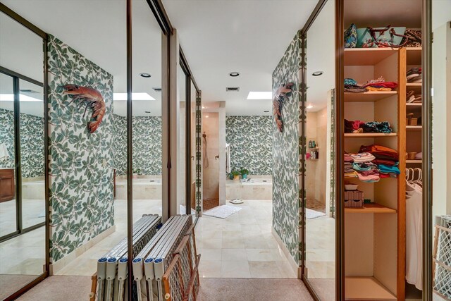 bathroom with a wealth of natural light and tile patterned floors