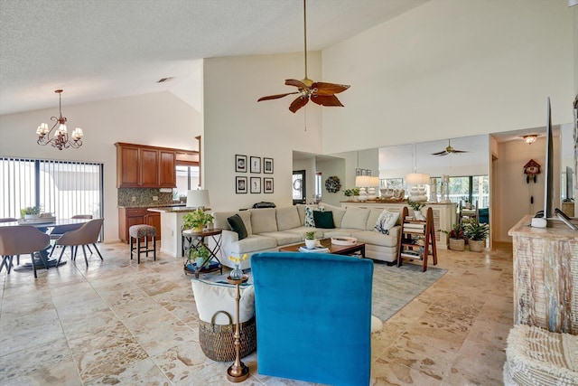 living room featuring high vaulted ceiling, a textured ceiling, and ceiling fan with notable chandelier