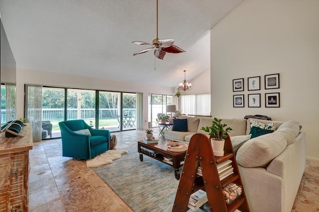 living room with high vaulted ceiling, a textured ceiling, and ceiling fan with notable chandelier