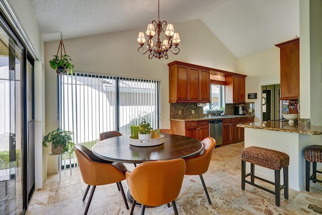 dining room with a healthy amount of sunlight, a textured ceiling, high vaulted ceiling, and a notable chandelier