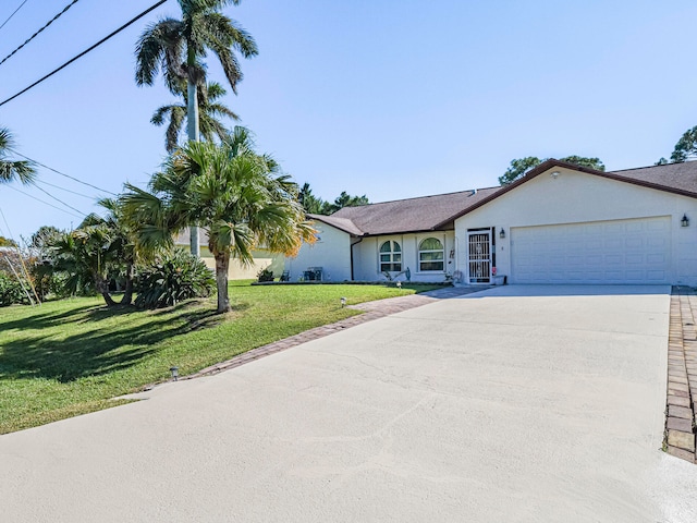 single story home featuring a front yard and a garage