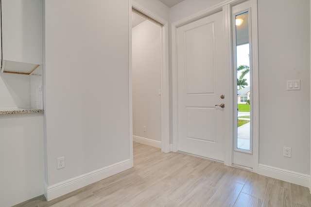 foyer entrance with light hardwood / wood-style floors