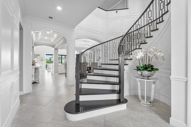 110 Echelon Crest Trl, Jupiter, FL 33478 - stairs with ornate columns, arched walkways, a decorative wall, ornamental molding, and recessed lighting