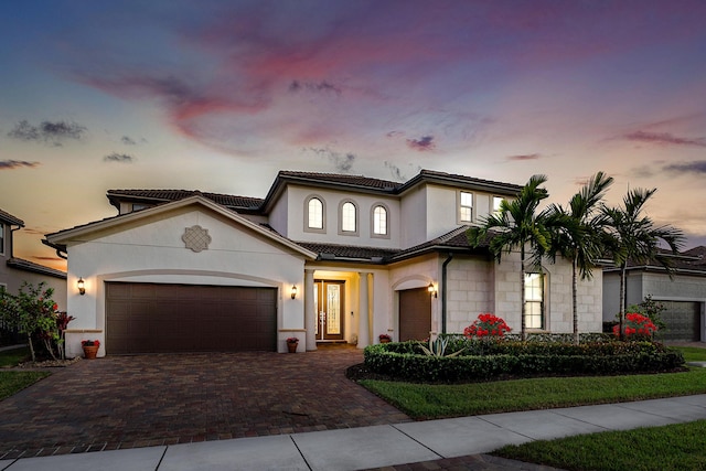 110 Echelon Crest Trl, Jupiter, FL 33478 - mediterranean / spanish-style house with decorative driveway, stucco siding, a garage, and a tiled roof