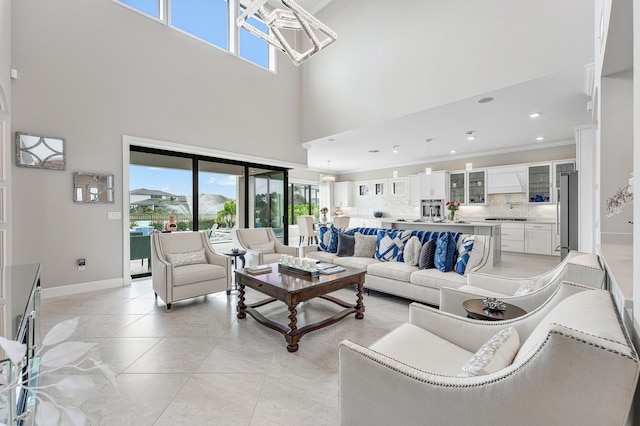 living room featuring light tile patterned floors, a towering ceiling, and a healthy amount of sunlight