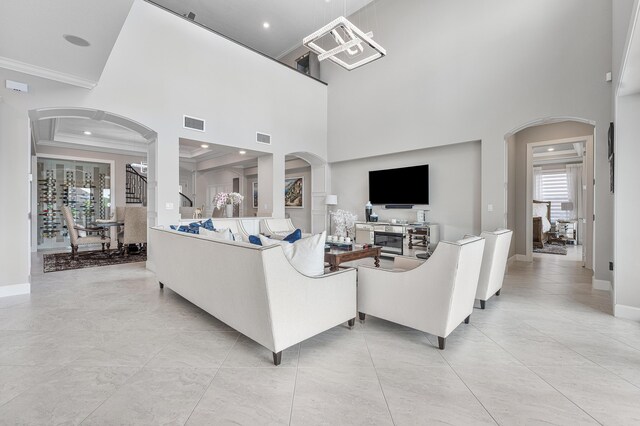 110 Echelon Crest Trl, Jupiter, FL 33478 - living room featuring arched walkways, ornamental molding, a towering ceiling, and recessed lighting