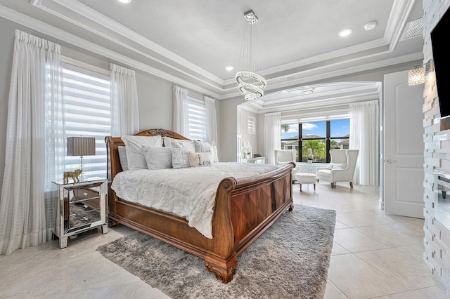 bedroom featuring a raised ceiling, light tile patterned flooring, a textured ceiling, and ornamental molding