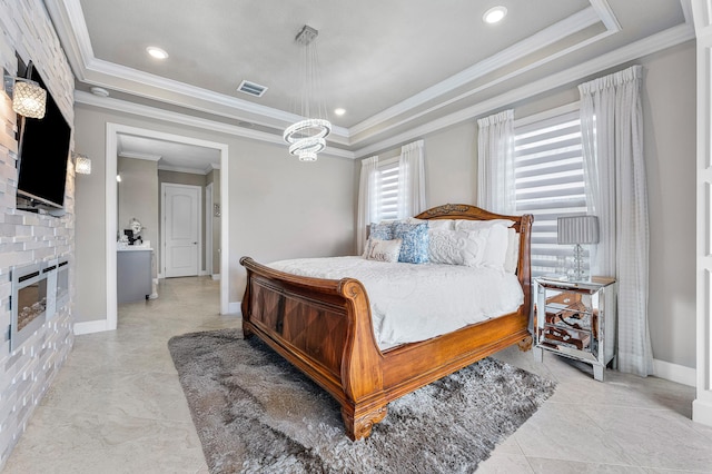 bedroom with a tray ceiling, an inviting chandelier, and crown molding