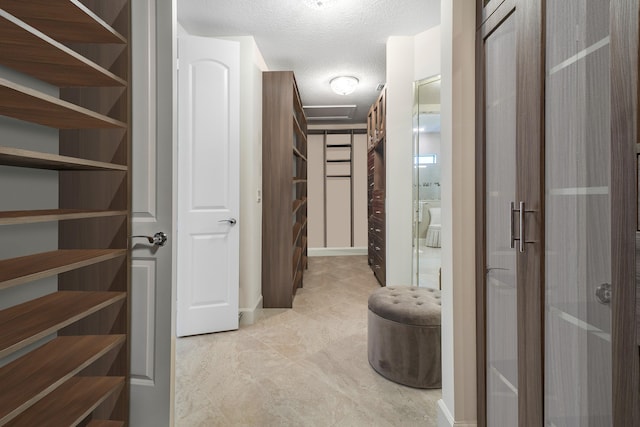 corridor featuring a textured ceiling