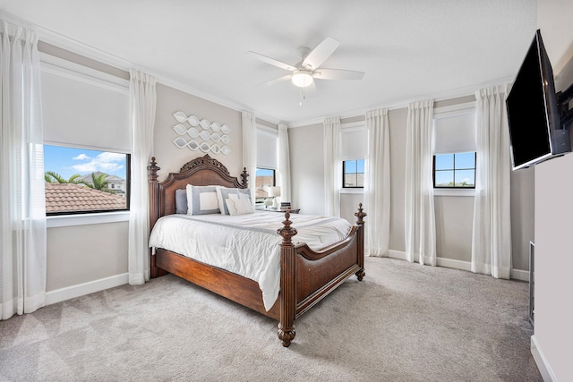 carpeted bedroom with ceiling fan and crown molding