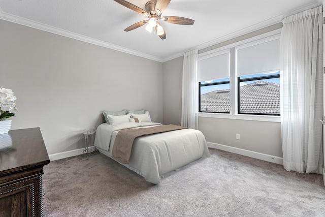 carpeted bedroom featuring ceiling fan and crown molding