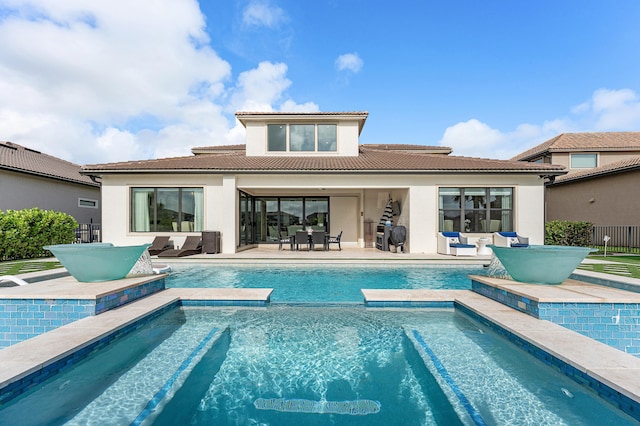 110 Echelon Crest Trl, Jupiter, FL 33478 - rear view of house featuring stucco siding, a tile roof, outdoor dining space, a patio, and a pool with connected hot tub