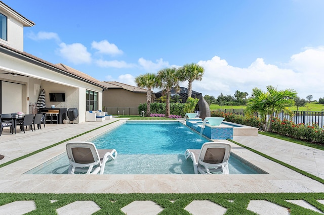 view of swimming pool featuring pool water feature, a patio area, an in ground hot tub, and an outdoor fire pit