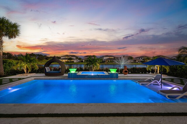 110 Echelon Crest Trl, Jupiter, FL 33478 - pool at dusk with a jacuzzi and a patio area