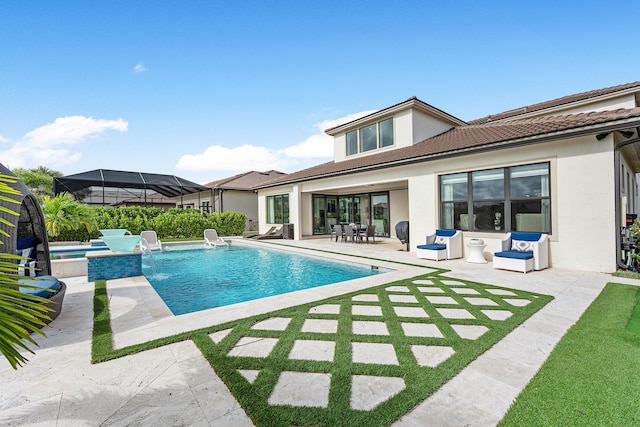 view of swimming pool with pool water feature, a patio, and a hot tub