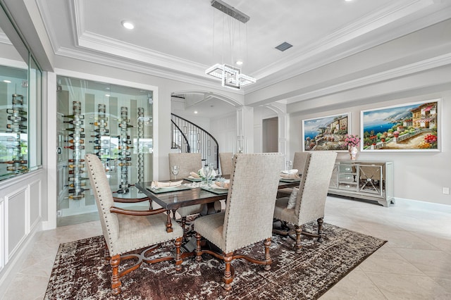 dining area featuring crown molding and a tray ceiling