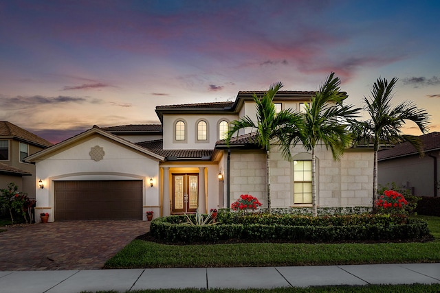 mediterranean / spanish-style home with french doors and a garage