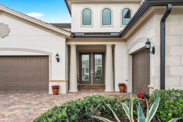 doorway to property featuring french doors and a garage