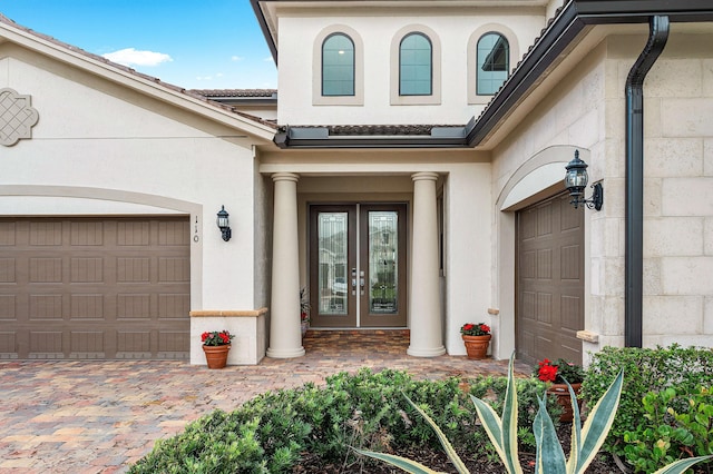 110 Echelon Crest Trl, Jupiter, FL 33478 - property entrance with french doors, a garage, and stucco siding