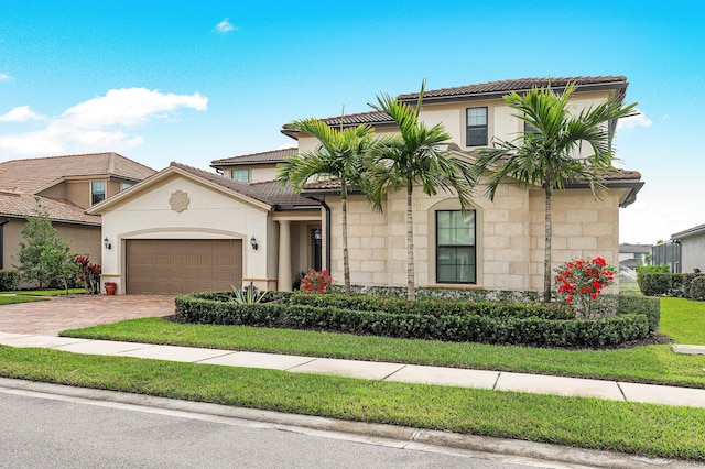 110 Echelon Crest Trl, Jupiter, FL 33478 - mediterranean / spanish house featuring stone siding, a garage, decorative driveway, and a tiled roof