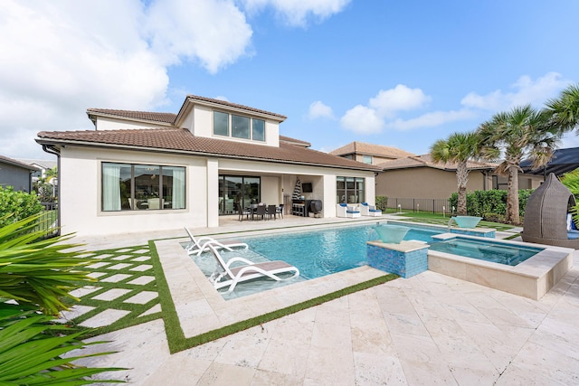 110 Echelon Crest Trl, Jupiter, FL 33478 - rear view of house featuring a tiled roof, a patio, stucco siding, and a pool with connected hot tub