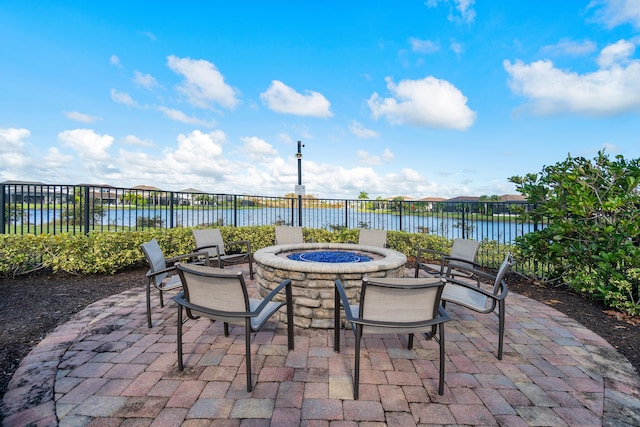 view of patio / terrace with a water view and an outdoor fire pit