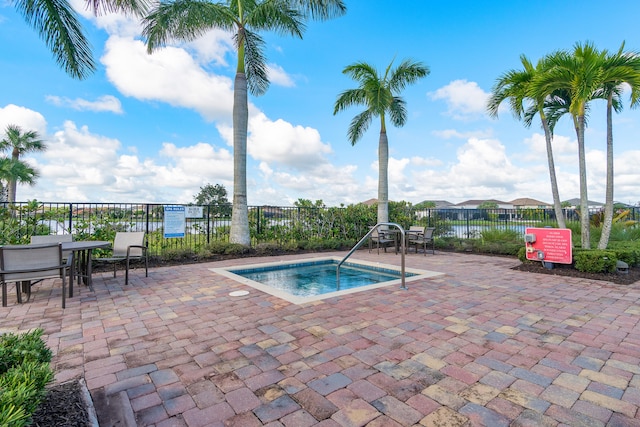 view of pool featuring a patio and a hot tub