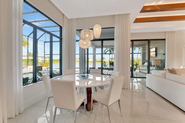 dining space featuring light tile patterned floors and a healthy amount of sunlight