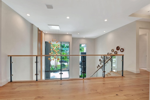 interior space with light wood-type flooring and a skylight